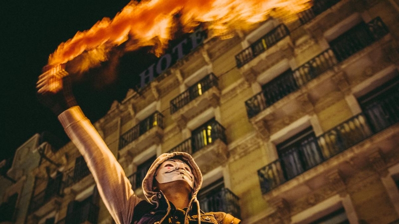 Un manifestante enciende una bengala durante una protesta por las restricciones del covid, a 11 de diciembre de 2021, en Barcelona.