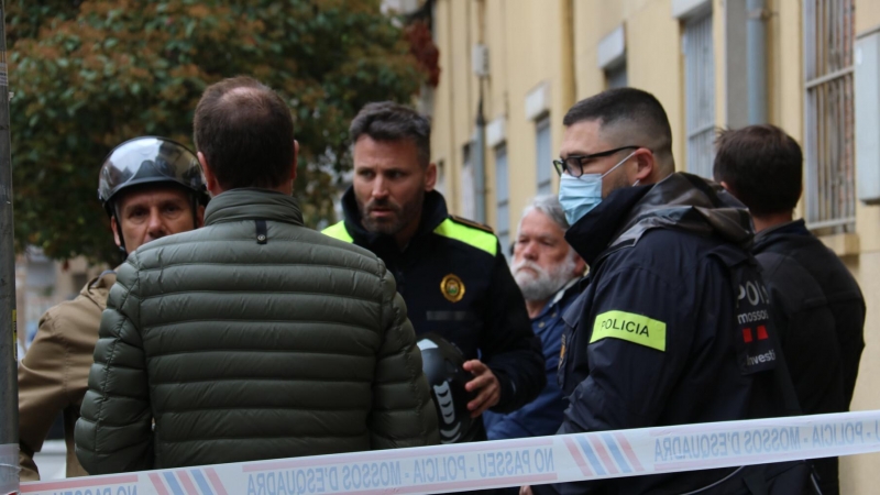 Diversos efectius dels cossos de seguretat davant del cordó policial al carrer on s'ha produït l'incendi a Santa Coloma de Gramenet.