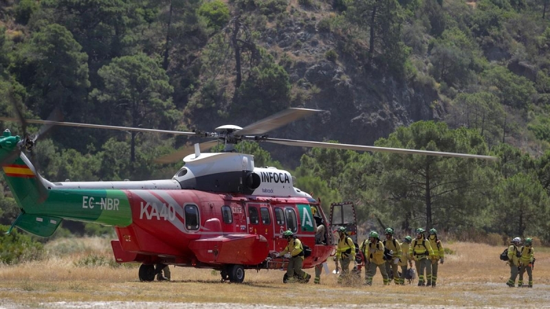 Bomberos que han estado trabajando toda la noche en el incendio forestal del Pujerra, llegan en helicóptero al puesto de mando a 09 de junio del 2022 en Pujerra (Málaga, Andalucía, España)