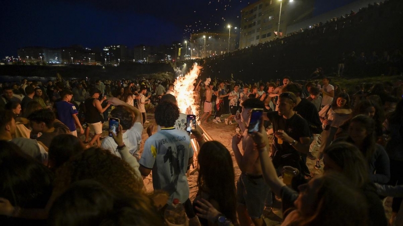 Centenares de personas frente a una hoguera en la Noche de San Juan, a 23 de junio de 2022, en A Coruña, Galicia.