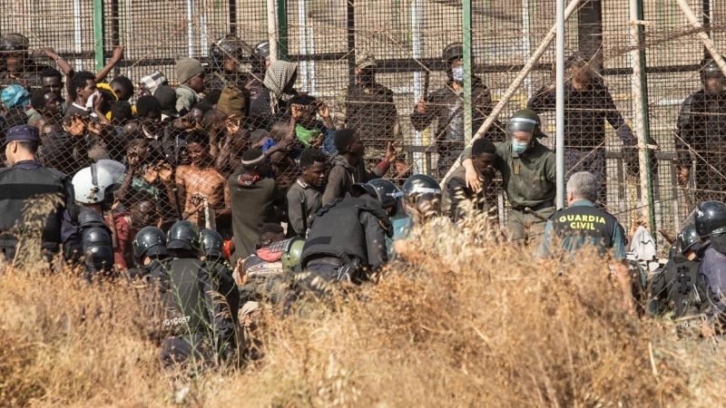 29/06/2022 Un miembro de las fuerzas de seguridad marroquí se lleva detenido a un migrante desde el lado español de la frontera con Melilla