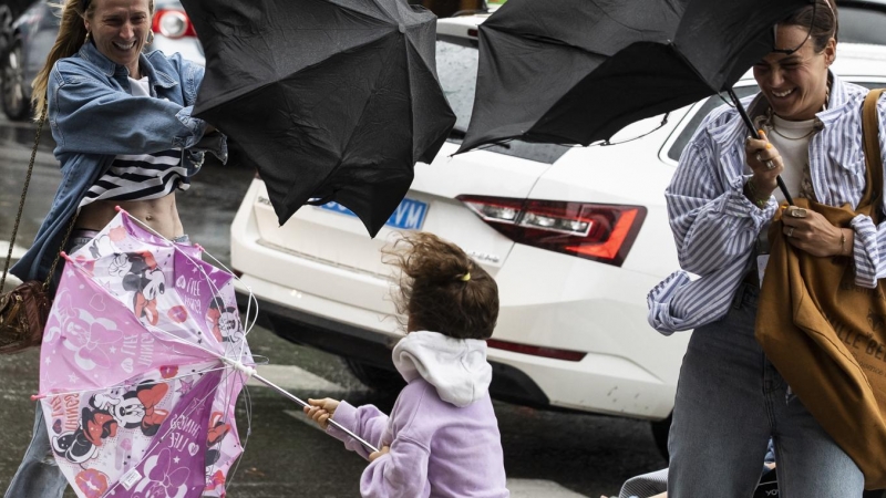 18/8/22 Varias personas tratan de dominar sus paraguas en Donostia, a 18 de agosto de 2022.