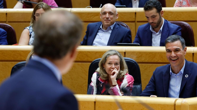 El presidente del Gobierno, Pedro Sánchez (d), y la vicepresidenta primera y ministra de Asuntos Económicos y Transformación Digital, Nadia Calviño (c), escuchan la intervención del líder del PP, Alberto Núñez Feijóo (i), durante el pleno del Senado cele