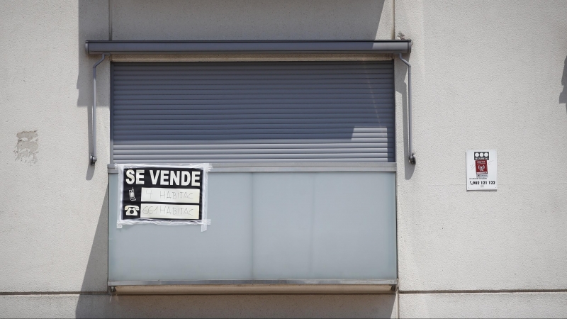 Cartel de se vende en el balcón de un piso de un edificio de Madrid.