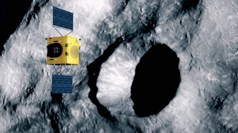 Ilustración de la nave Hera escaneando el cráter de impacto formado por la sonda DART al chocar contra el asteroide Dimorphos.
