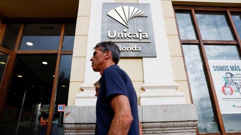 Un hombre pasa por delante de unas oficinas de Unicaja en Ronda (Málaga). REUTERS/Jon Nazca