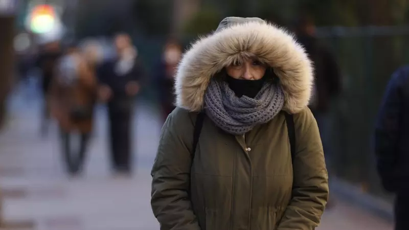 Una mujer pasea por Madrid cuando la capital se encuentra en aviso amarillo por temperaturas mínimas.