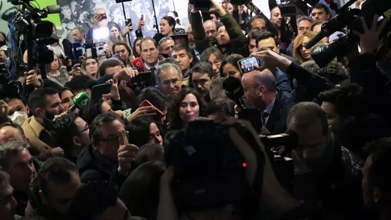 La presidenta madrileña, Isabel Díaz Ayuso, rodeada de periodistas abandona la facultad de Ciencias de la Información de la Universidad Complutense de Madrid tras recoger el premio como 'alumna ilustre' de la facultad en la que se formó.