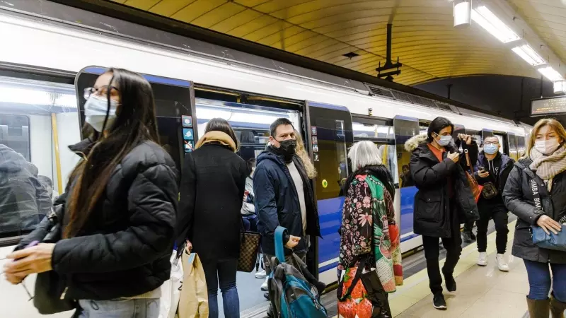 Varias personas bajan y suben de un metro en el andén de la estación de Metro de Callao, a 26 de enero de 2023, en Madrid (España).