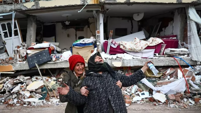 Dos mujeres se lamentan junto a un edificio derrumbado tras el gran terremoto en el distrito de Elbistan de Kahramanmaras, en Turquía.