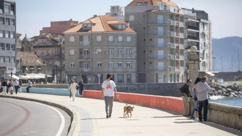 Varias personas pasean por el Paseo Marítimo de Sanxenxo, en Pontevedra, Galicia, a 27 de marzo de 2021.