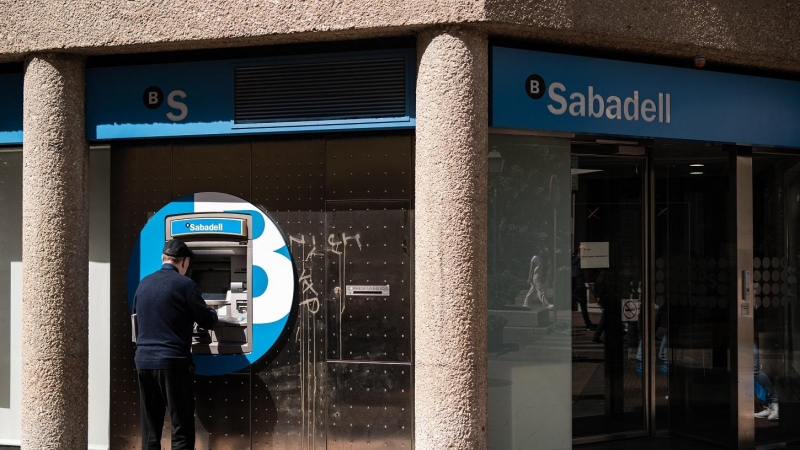 Un hombre opera el cajero automático de una oficina del Banco Sabadell en Madrid. E.P./Diego Radamés
