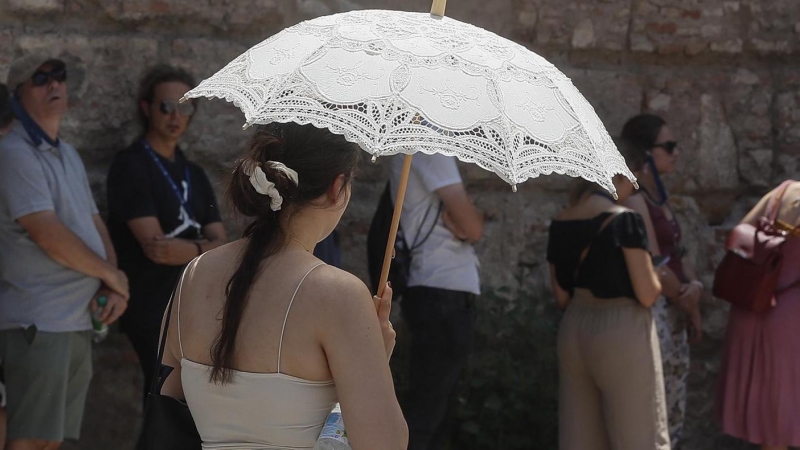 Unos turistas esperan en el trozo de sombra para entrar al Real Alcázar de Sevilla, este lunes cuando la Agencia Estatal de Meteorología (AEMET) alerta de temperaturas significativamente altas, que pueden alcanzar los 44 grados en el valle del Guadalquivi