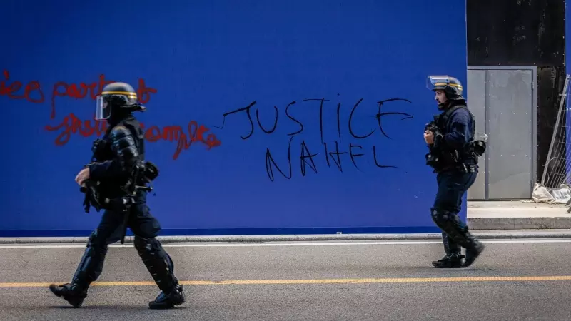 Policías antidisturbios frente a una pintada pidiendo 'Justicia para Nahel' en París, Francia