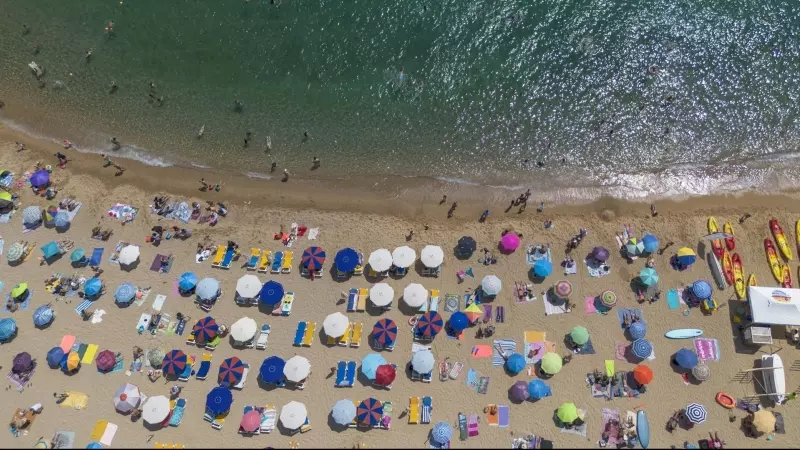 Numerosas personas disfrutan de un día de playa en la Costa Brava, a 30 de julio de 2023, en Tossa de Mar, Girona, Catalunya.