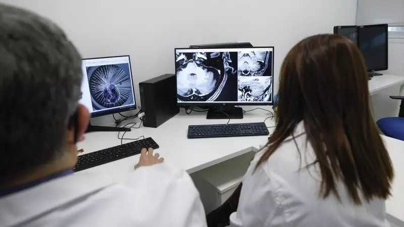 Foto de archivo de unos sanitarios observando la radiografía de un cerebro.
