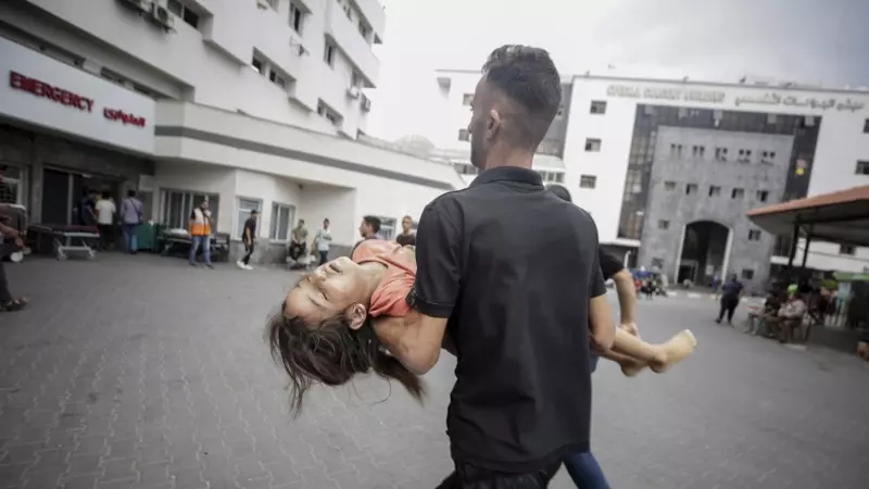Un palestino lleva a una niña herida al hospital Al-Shifa en la ciudad de Gaza, el 9 de octubre de 2023. Los hospitales gazatíes están practiacamente colapsados tras el bloqueo israelí que impide el acceso de combustible y material humanitario. No hay luz