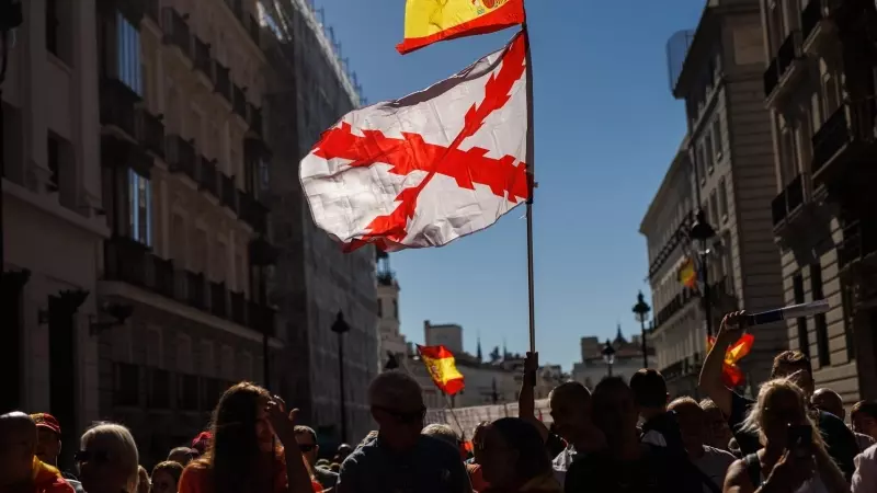 Varias personas portan una bandera de España y otra con la cruz de Borgoña, la bandera de los tercios, durante una manifestación de los 'chalecos amarillos' para protestar contra el Gobierno, el 10 de septiembre de 2022.