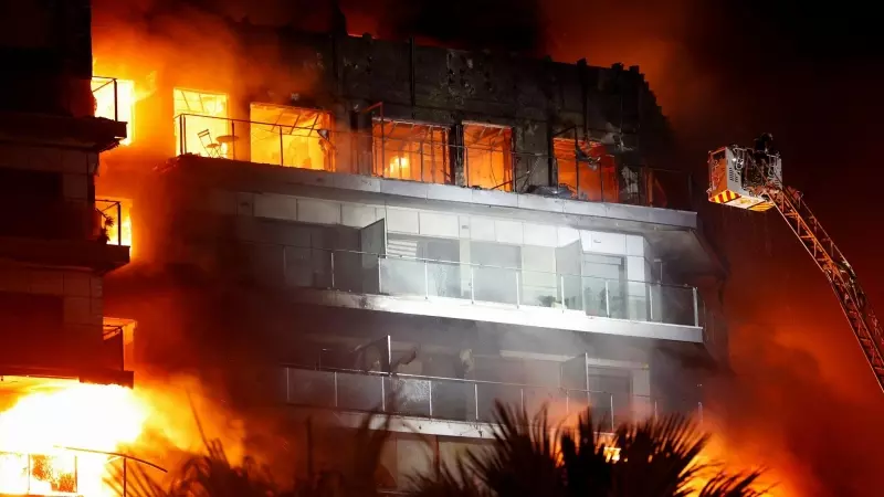 Firefighters work at the scene of a fire of apartment building in Valencia, Spain