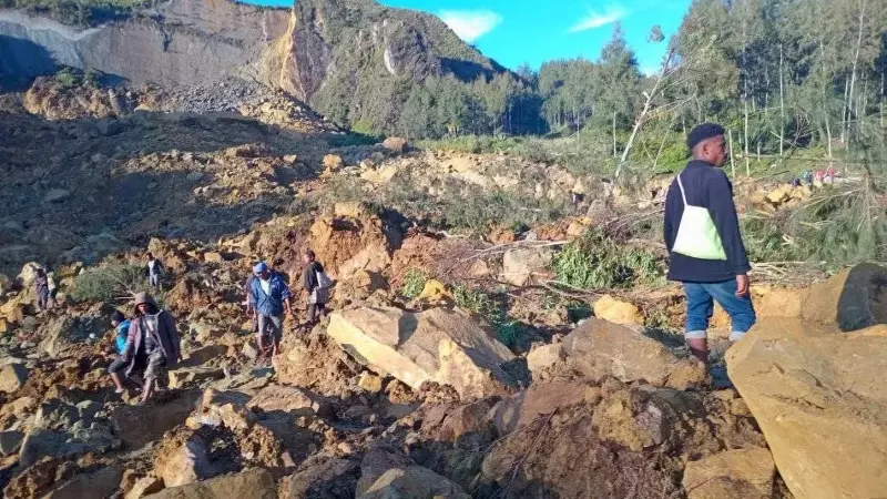 Personas sobre el deslizamiento de tierra originado en la aldea Kaokalam en la provincia de Enga, Papúa Nueva Guinea, a 24 de mayo de 2024.
