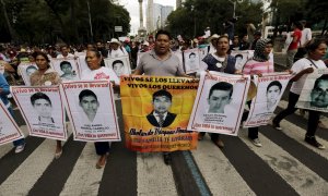 Manifestantes con las fotos de los 43 estudiantes desaparecidos en Iguala, México. REUTERS