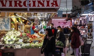 23/06/2022. Varias personas compran en un puesto de fruta y verdura en el Mercado Central de Valencia, a 24 de marzo de 2022.