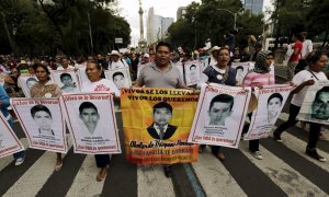 Manifestantes con las fotos de los 43 estudiantes desaparecidos en Iguala, México. REUTERS