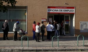 Desempleados hacen cola en una oficina de empleo | REUTERS