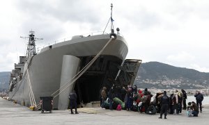 Un grupo de refugiados embarca en el buque militar enviado por el Gobierno griego a la isla de Lesbos.- REUTERS