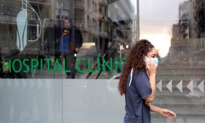 Woman in a protective face mask walks out of a Hospital Clinic, where a case of novel coronavirus has been confirmed, in Barcelona | reuters