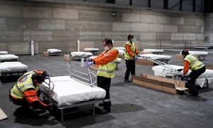 Personal sanitario prepara camas en uno de los pabellones del recinto ferial Ifema, que se preparan para albergar 1.396 camas para atender a pacientes de coronavirus, el sábado, en Madrid. EFE/ Comunidad De Madrid