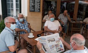 Un grupo de amigos con mascarilla desayuna en un bar de la localidad de Es Mercadal, Menorca | EFE