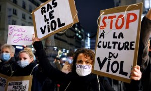 Manifestantes sostienen carteles, incluido uno que decía "Alto a la cultura de la violación" el 18 de noviembre de 2020, en París, durante una manifestación.