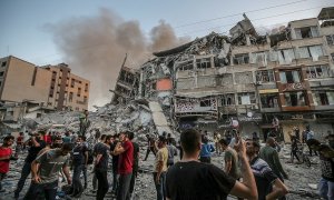 Los palestinos inspeccionan los escombros del destruido Al-Shorouq twoer después de un ataque israelí en la ciudad de Gaza, el 12 de mayo de 2021.