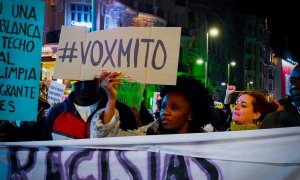 Una mujer sostiene una pancarta contra Vox durante la marcha antirracista de Madrid.