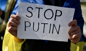 Un manifestante sostiene un cartel que dice 'Stop Putin' durante una protesta contra la operación militar de Rusia en Ucrania, frente al consulado ruso en Barcelona el 24 de febrero de 2022.
