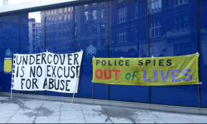 24/05/2022 - Imagen sobre las protestas de SpyCops tomada por una de las víctimas. En los carteles se lee: "La clandestinidad no es excusa para el abuso." Y "los espías de la policía fuera de las vidas".