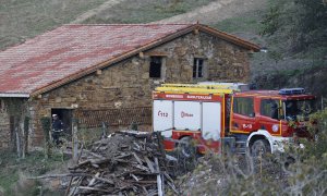 En la imagen, los bomberos protegen un caserío en los montes de Bizkaia a causa del incendio forestal que se originó este domingo en el municipio de Balmaseda (Bizkaia).