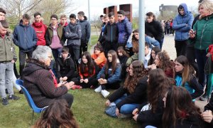 Unos jóvenes escuchan el relato de una mujer en el Parque de la Memoria de la localidad navarra de Sartaguda.