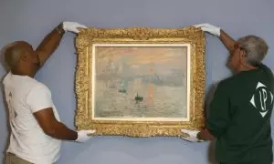 Empleados del Musee Marmottan Monet sostienen la pintura "Impression, Sunrise" ("Impression soleil levant") del pintor francés Claude Monet.