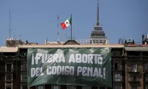 Una pancarta que dice: "Aborto fuera del Código Penal" cuelga de un edificio durante el Día Internacional de la Mujer, en la Plaza del Zócalo en la Ciudad de México, México, el 8 de marzo de 2023.