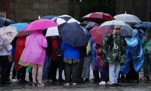 Un grupo de personas con paraguas durante el paso de la borrasca ‘Aline’, a 19 de octubre de 2023, en Santiago de Compostela, A Coruña, Galicia