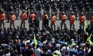Members of the police and the Naval Prefecture stand guard as demonstrators gather near the Pueyrredon bridge during a one-day national strike, in Buenos Aires, Argentina, January 24, 2024.