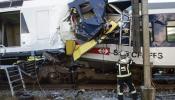 Los bomberos rescatan el cadáver del maquinista de uno de los trenes que chocaron en Suiza