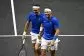 Roger Federer y Rafa Nadal se dan la mano emocionados durante un momento del partido de despedida del tenis del suizo.- Dylan Martinez / Reuters