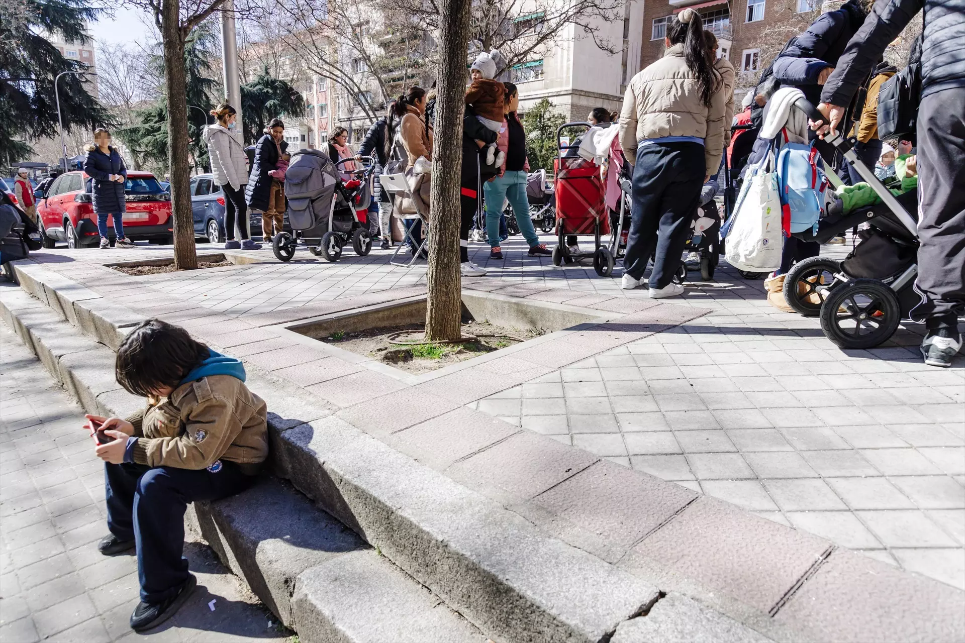 Un grupo de personas espera en cola durante la entrega de ropa de abrigo y zapatos nuevos a niños vulnerables en Madrid. — Carlos Luján / Europa Press